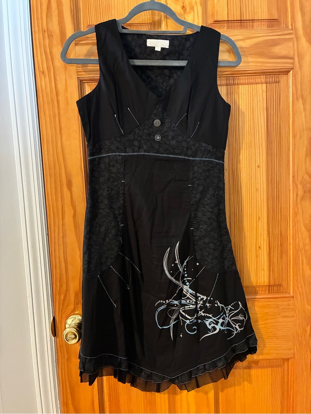 Whimsy Sleeveless Black A-Line Dress with Subtle Graphic Detail